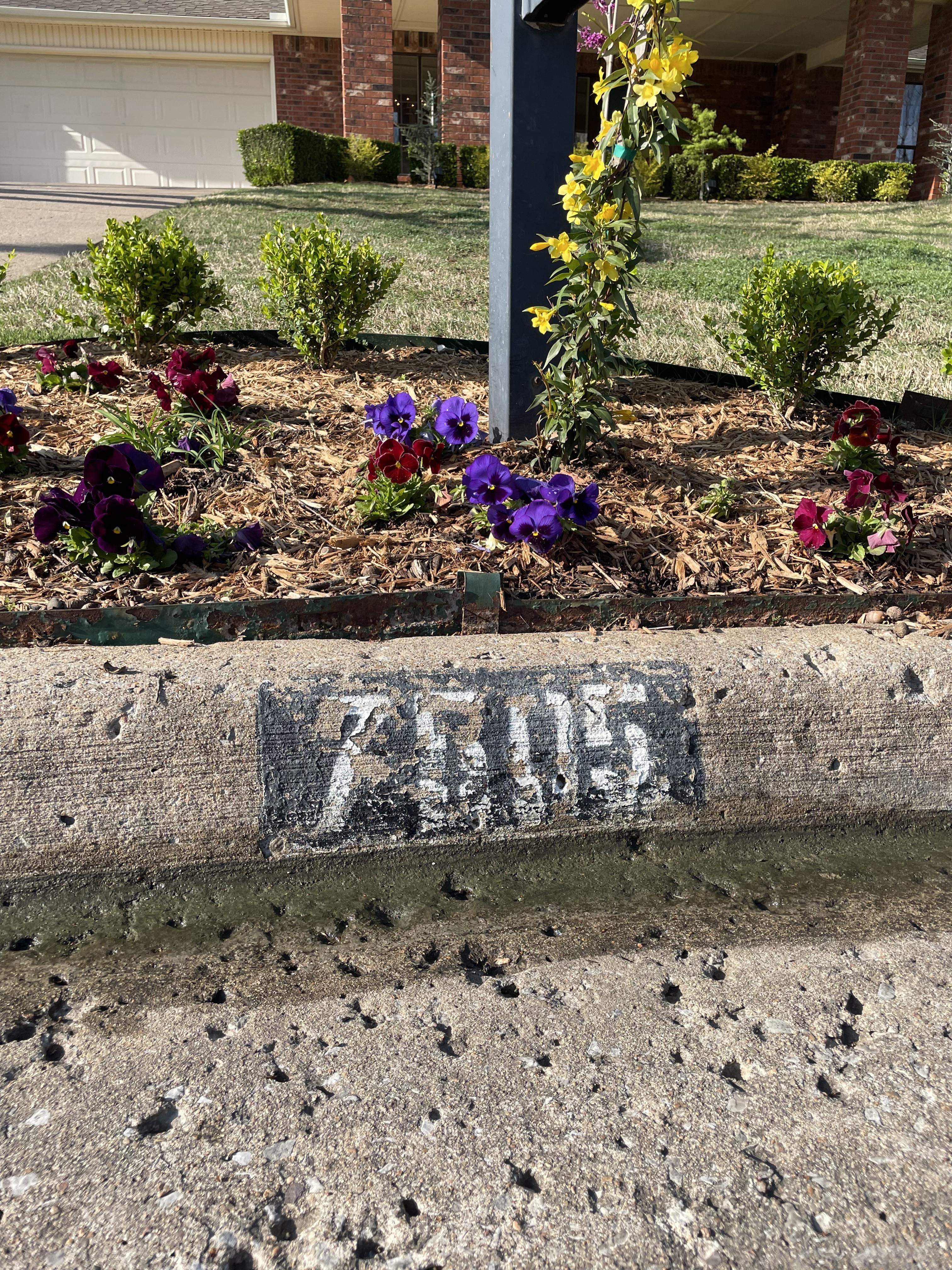 Before — faded curb address number in need of repainting